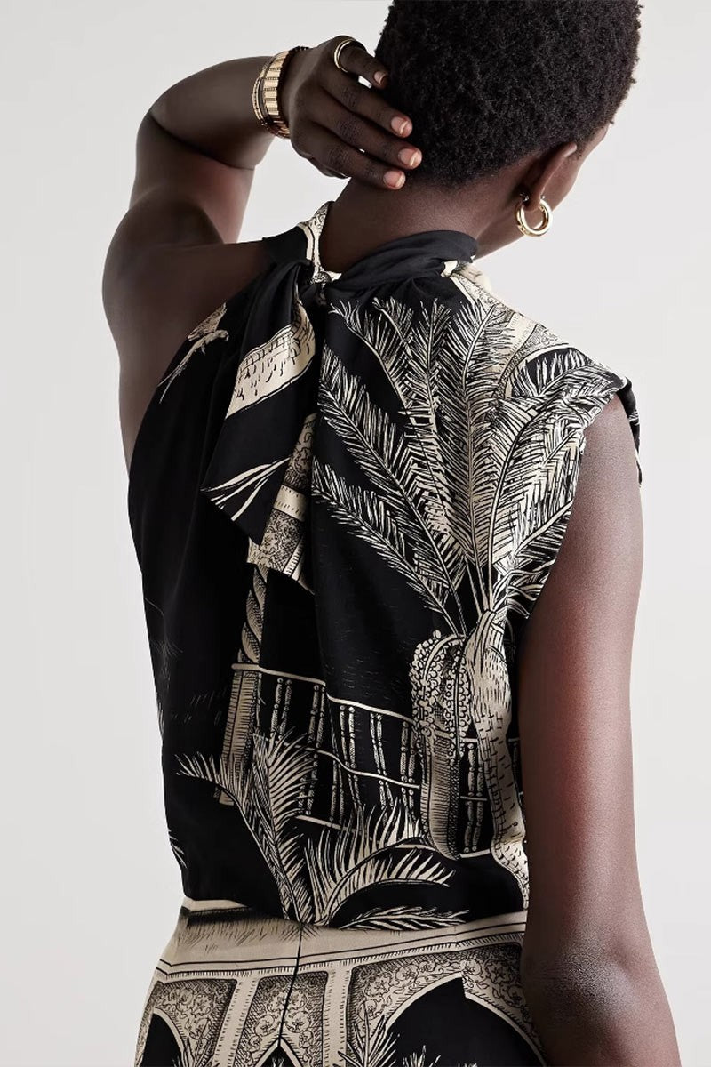 Side view of model showing draped neckline and shoulder details of the top.