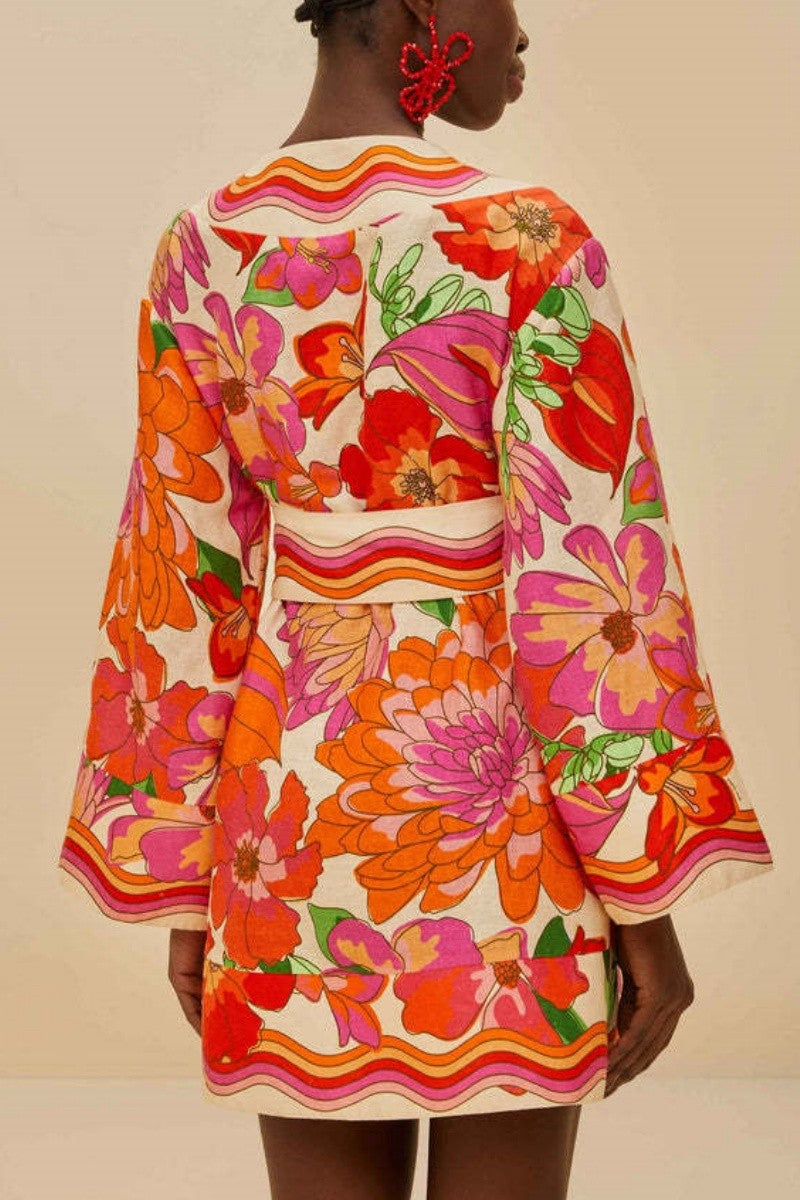 Back view of dress displaying bold floral design and loose fit