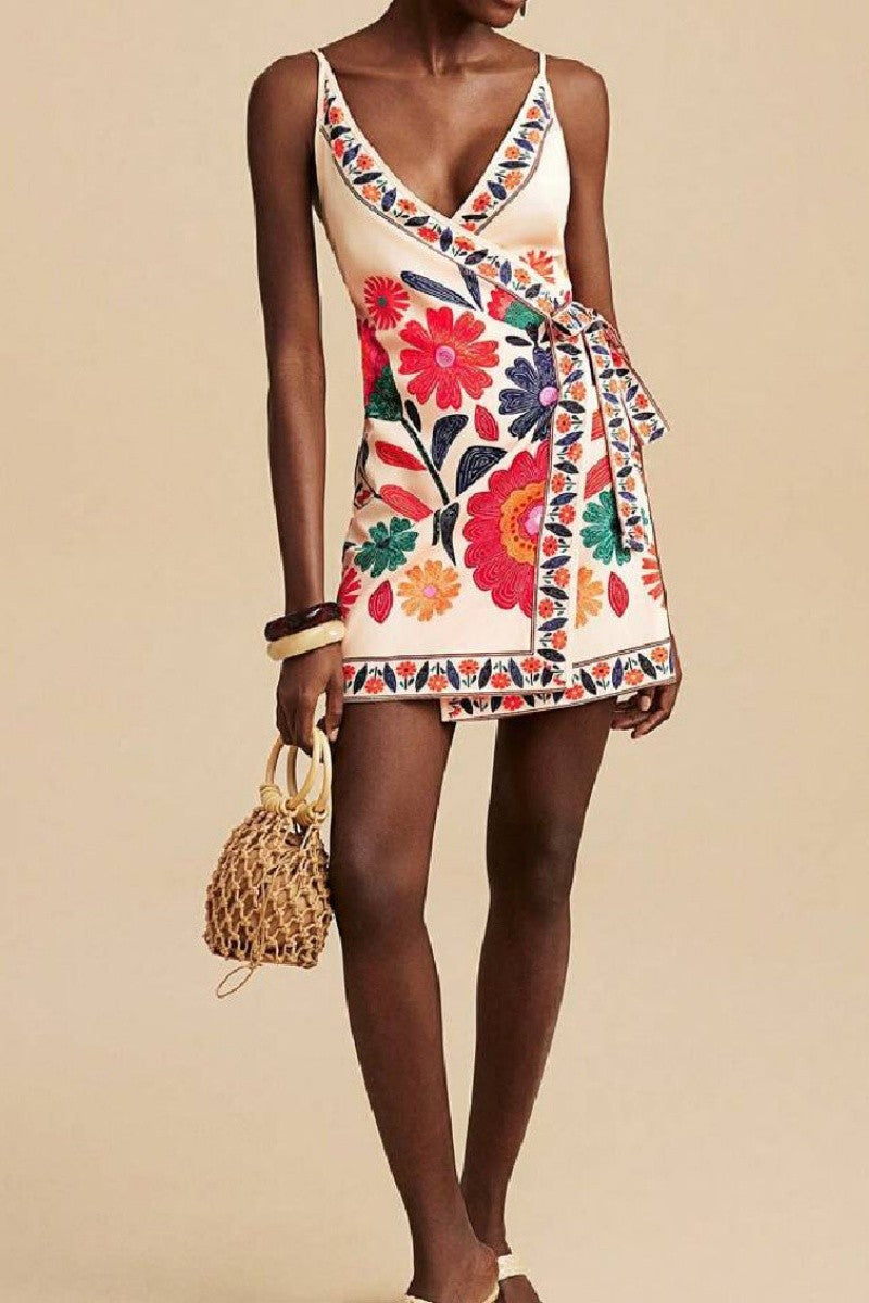 Close-up of waist tie and embroidered floral trim on wrap mini dress