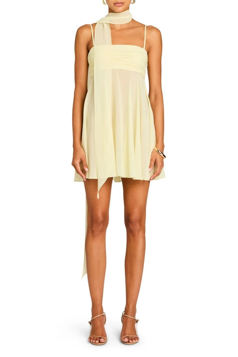Model standing straight in yellow chiffon mini, full length view