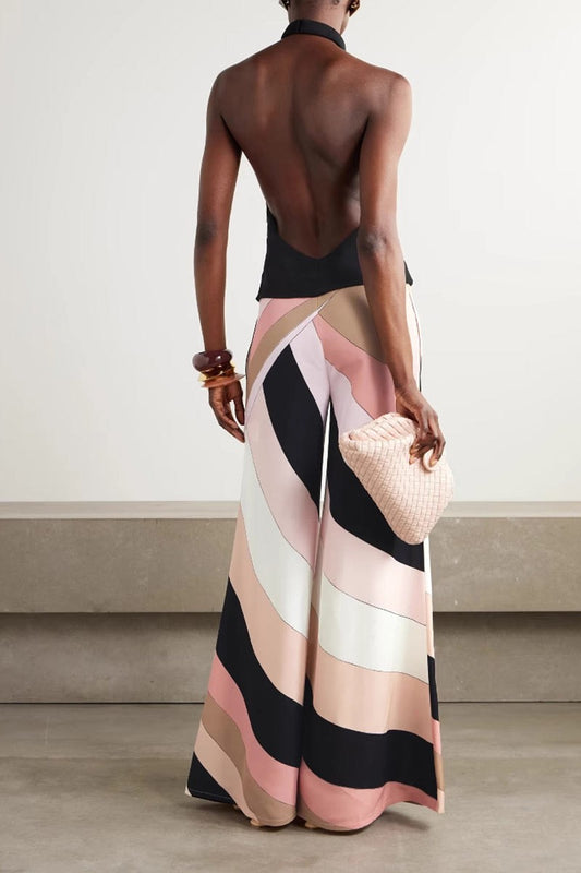 Back view of halter jumpsuit showing open-back detail and bold stripe pattern on wide-leg pants