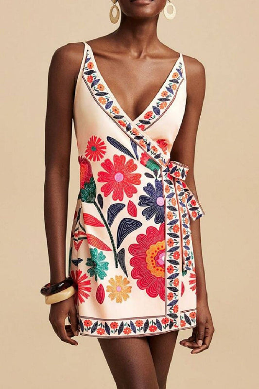 Front view of model wearing floral wrap mini dress with V-neck and side tie